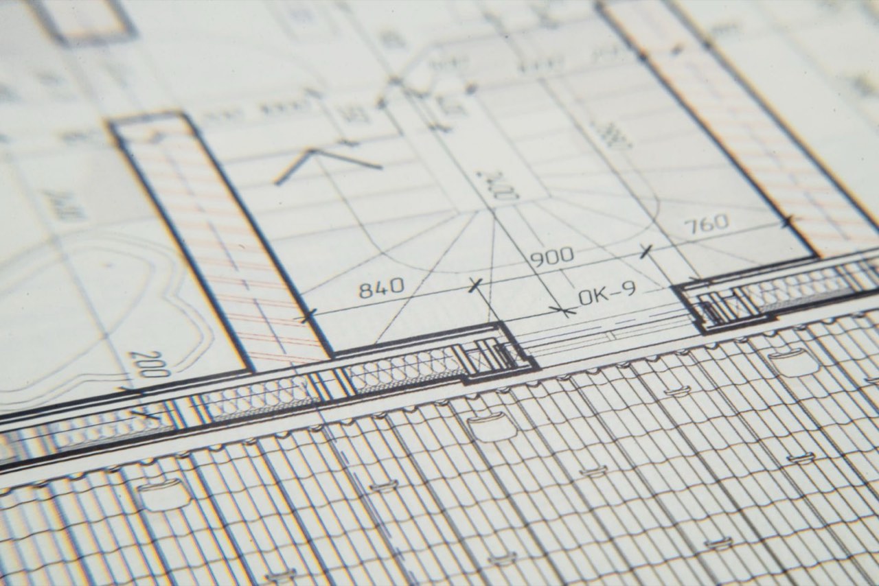 A floor plan drawn in fine white lines on blue paper, walls and dimensions in close-up