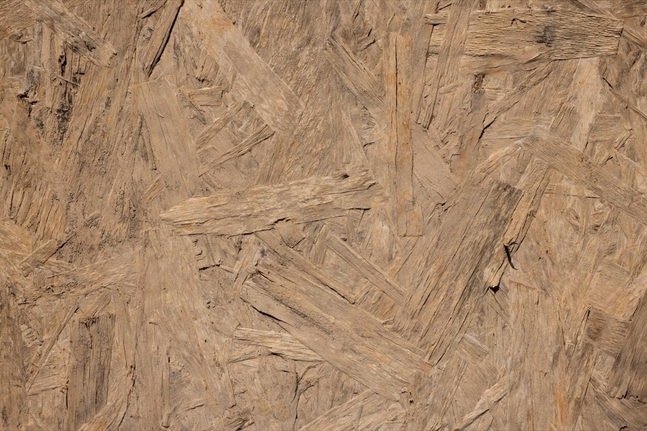 The surface of an oriented strand board panel, wood flakes pressed in every direction